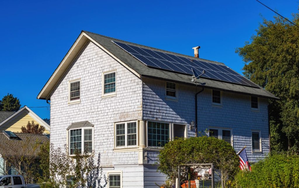 Two-storey home with a residential solar panel system on its roof