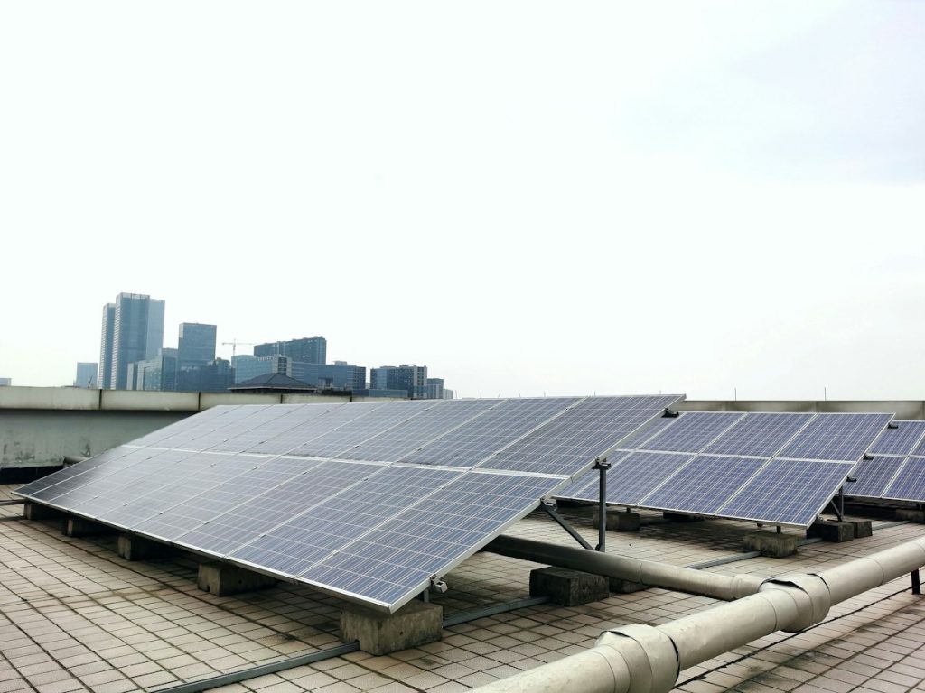 A neat row of solar panels mounted on a rooftop