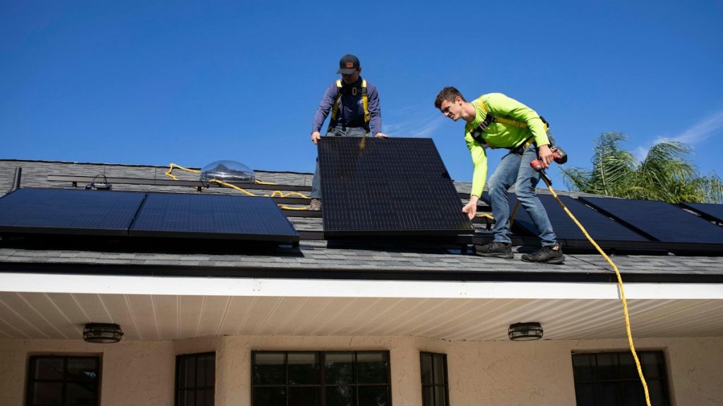 Solar crew working together on a roof installation