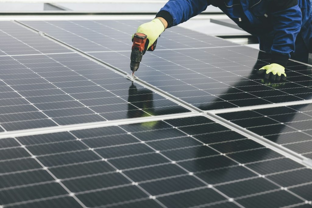 Technician inspecting a solar panel during a service visit