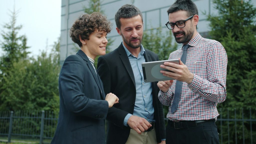 Project team reviewing a solar system plan on a tablet