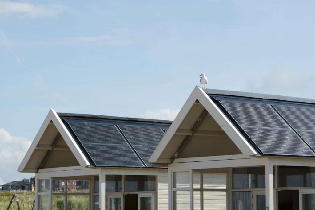Two gabled homes with solar panels covering their roofs